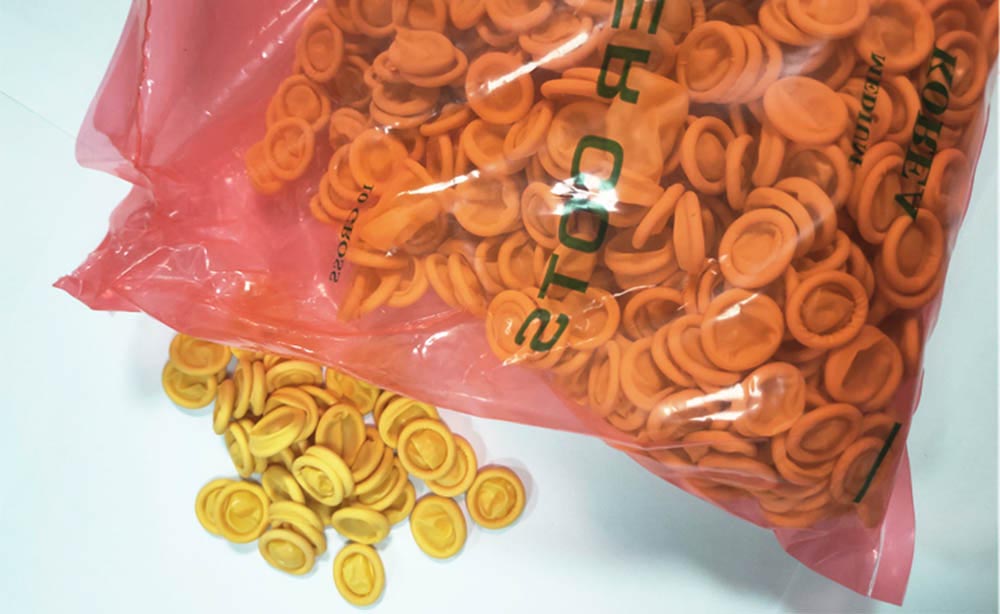 Jednorazowe pomarańczowo-żółte antypoślizgowe lateksowe przemysłowe nakładki na palce