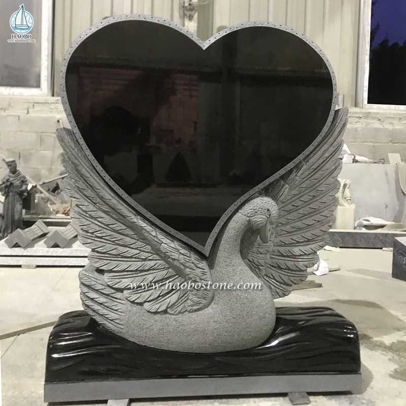 Czarny granitowy nagrobek w kształcie serca z rzeźbionym łabędziem
